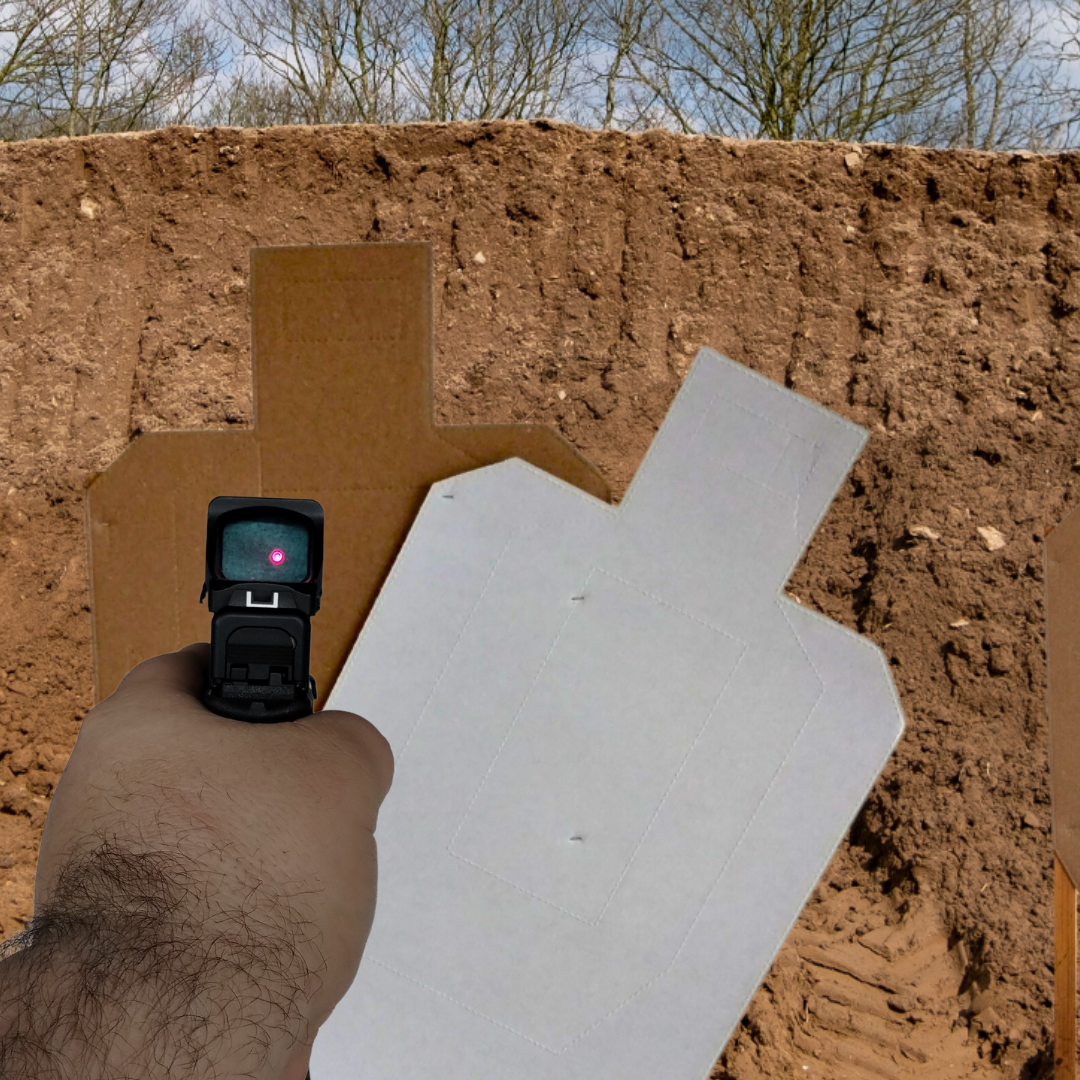 a person holding a gun with occulded red dot